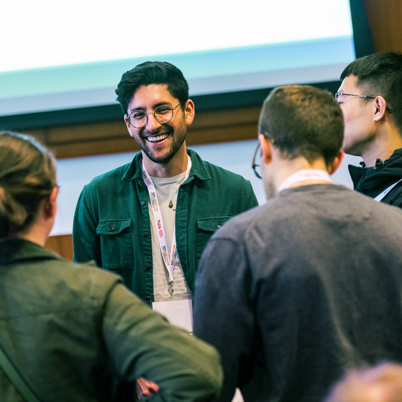 Group of kids looking into a light desk.