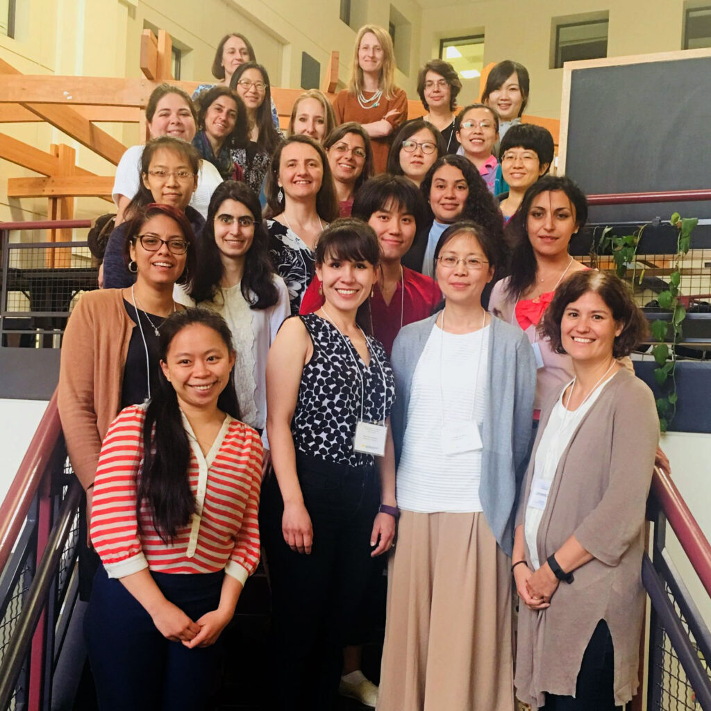 Group photo of smiling people on a staircase.